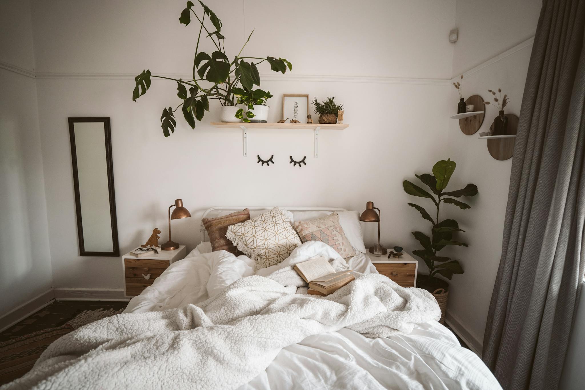 A modern bedroom interior with minimalistic design, plants, and cozy textiles, perfect for home decor inspiration.