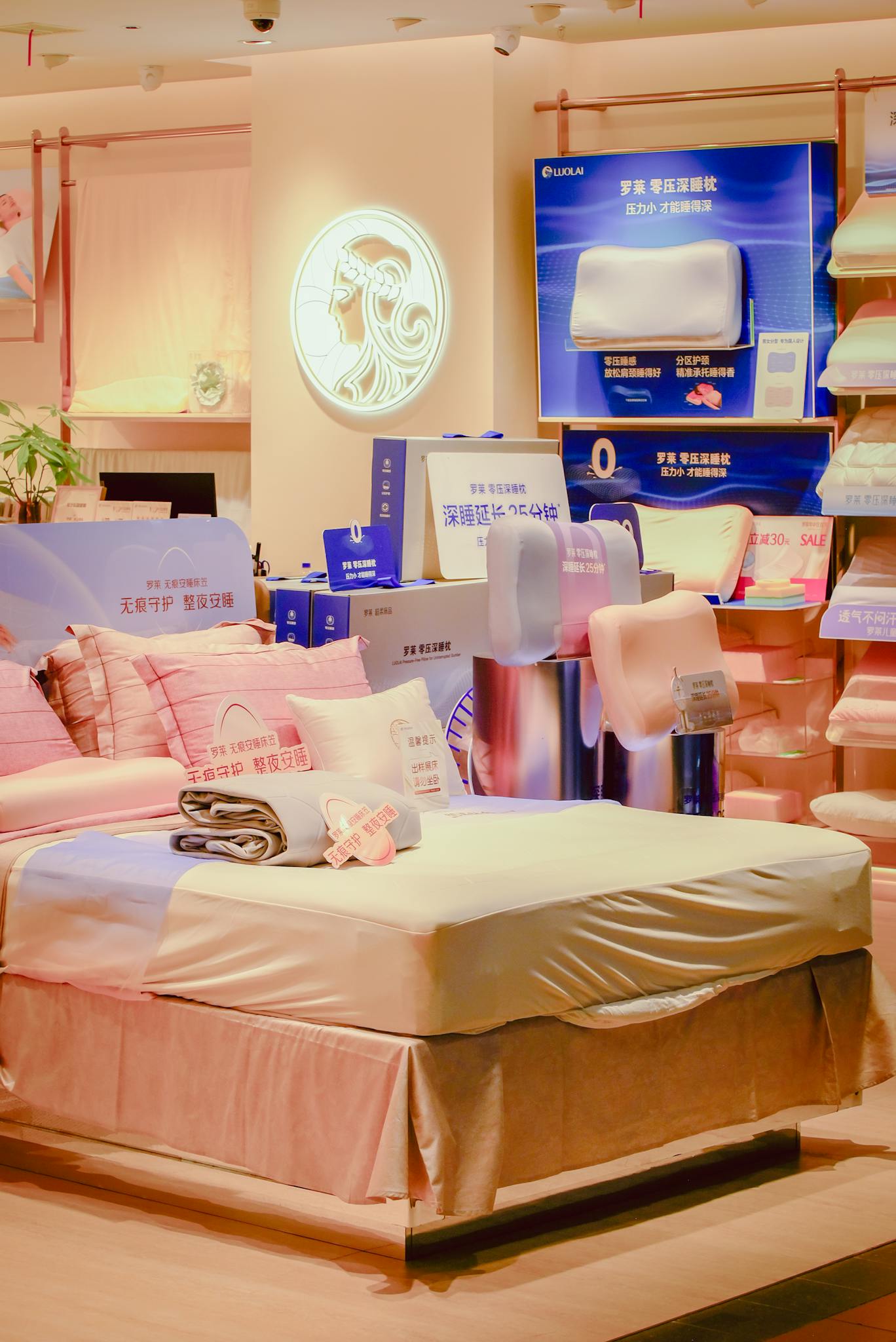 Inviting bedroom setup featuring pink bedding and pillows in a stylish home décor shop.