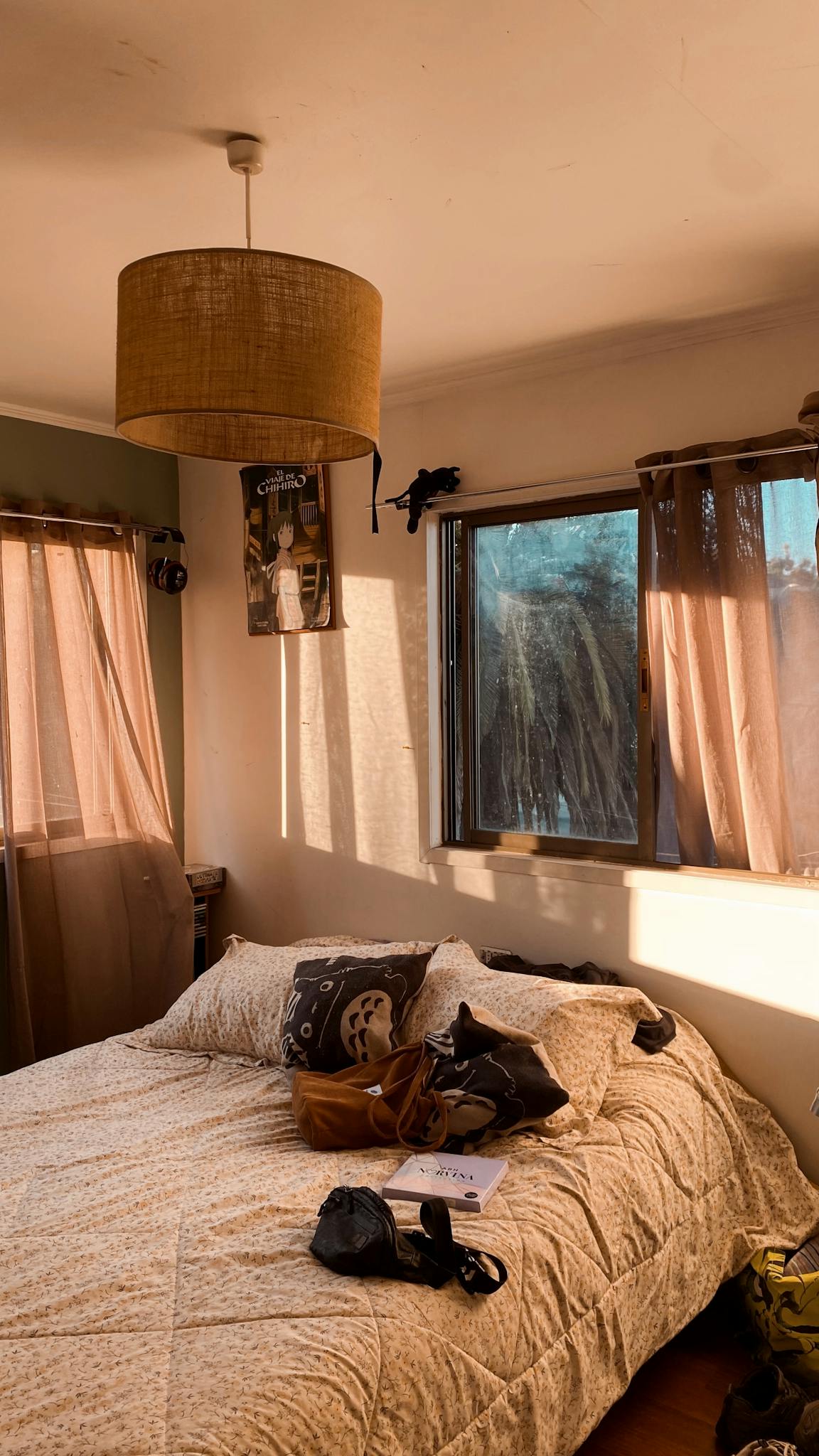 Warm sunlit bedroom with modern decor and cozy bedding. Perfect for lifestyle or interior design themes.